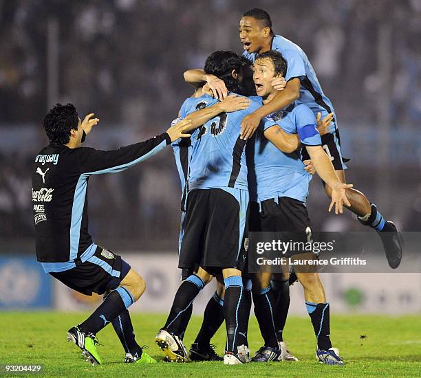 Diego Lugano of Uruguay celebrates with goal scorer Sebastian Abreu after qualifying for the 2010 FIFA World Cup Play Off Second Leg Match between...