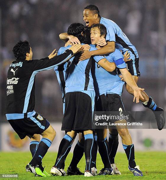 Diego Lugano of Uruguay celebrates with Sebastian Abreu after the 2010 FIFA World Cup Play Off Second Leg Match between Uruguay and Costa Rica at The...