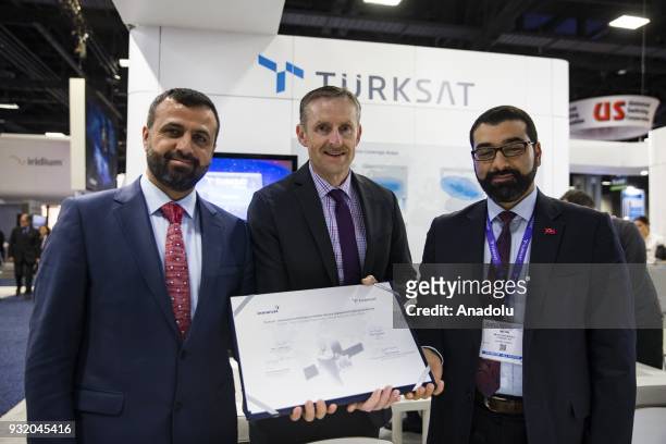 Hasan Huseyin Ertok , Vice President of Turksat, Todd McDonell, Vice President at Inmarsat, and Metin Cavusoglu, Vice President at Turksat, pose with...