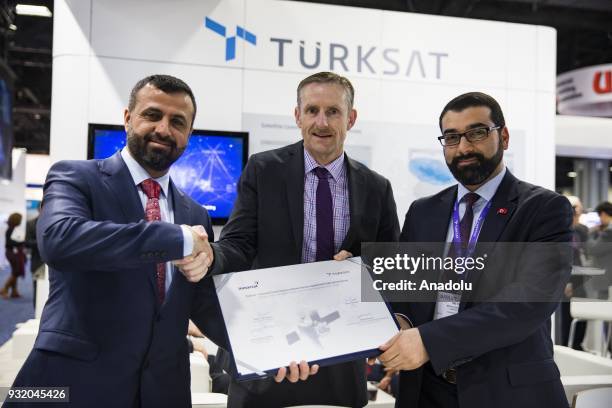 Hasan Huseyin Ertok , Vice President of Turksat, Todd McDonell, Vice President at Inmarsat, and Metin Cavusoglu, Vice President at Turksat, pose with...