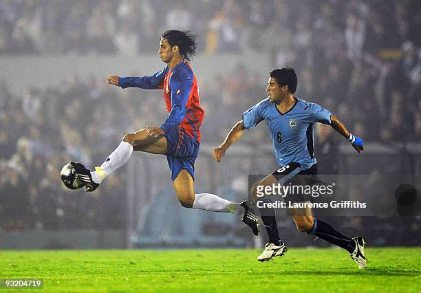 Andres Scotti of Costa Rica battles with Ruiz Gonzalez of Costa Rica duing the 2010 FIFA World Cup Play Off Second Leg Match between Uruguay and...