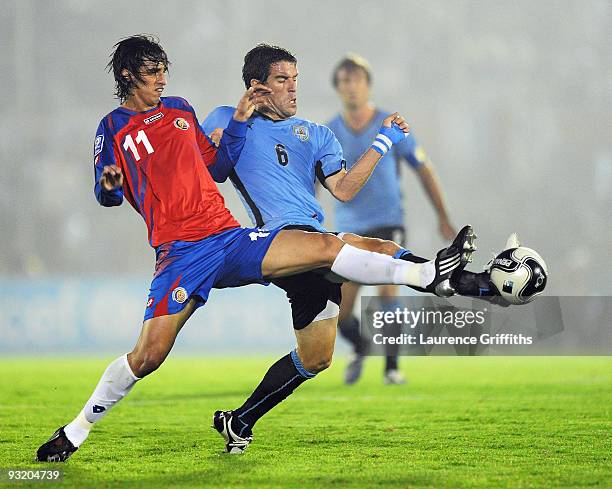 Andres Scotti of Costa Rica battles with Ruiz Gonzalez of Costa Rica duing the 2010 FIFA World Cup Play Off Second Leg Match between Uruguay and...