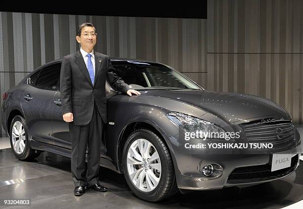 Of Japanese auto giant Nissan Motor, Toshiyuki Shiga, poses next to the company's new luxury sedan "Fuga", equipped with 2.5 or 3.7-litre V6 engines,...