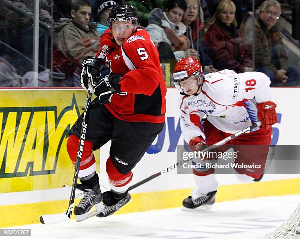 Nicolas Deslauriers of the QMJHL All-Stars and Dmitri Kugryshev of the Russia All-Stars chase the puck into the corner during Game 2 of the 2009...