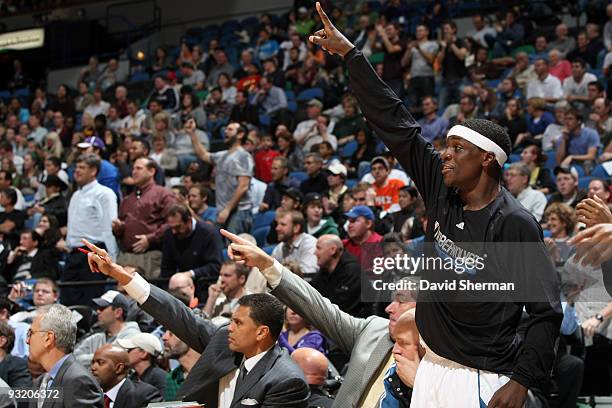 Assistant Coach Reggie Theus, Assistant Coach Bill Laimbeer, and Jonny Flynn of the Minnesota Timberwolves cheer on their team during the game...