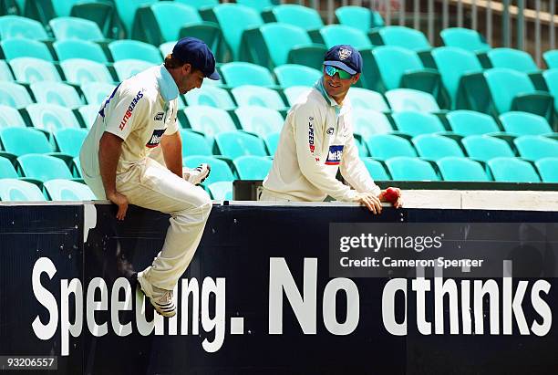 Phillip Hughes of the Blues and team mate Michael Clarke retrieve the ball during day three of the Sheffield Shield match between the New South Wales...