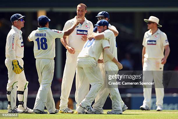 Stuart Clark of the Blues celebrates with team mates after dismissing George Bailey of the Tigers during day three of the Sheffield Shield match...