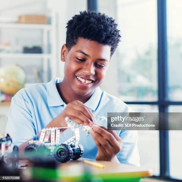 african american high school student building robot - african american school uniform stock pictures, royalty-free photos & images