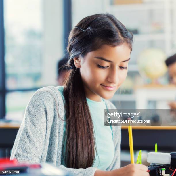female high school student works on class assignment - junior high stock pictures, royalty-free photos & images