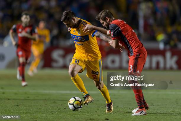 Andre-Pierre Gignac of Tigres fights for the ball with Drew Moor of Toronto during the quarterfinals second leg match between Tigres UANL and Toronto...