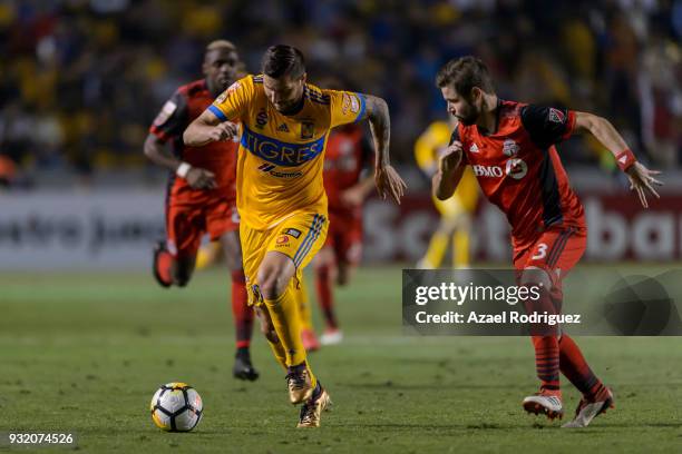 Andre-Pierre Gignac of Tigres fights for the ball with Drew Moor of Toronto during the quarterfinals second leg match between Tigres UANL and Toronto...