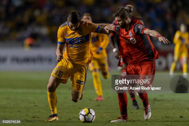 Andre-Pierre Gignac of Tigres fights for the ball with Drew Moor of Toronto during the quarterfinals second leg match between Tigres UANL and Toronto...