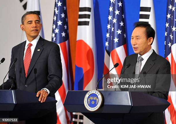 President Barack Obama listens as South Korean President Lee Myung-Bak speaks during a joint press conference at the presidential Blue House in Seoul...