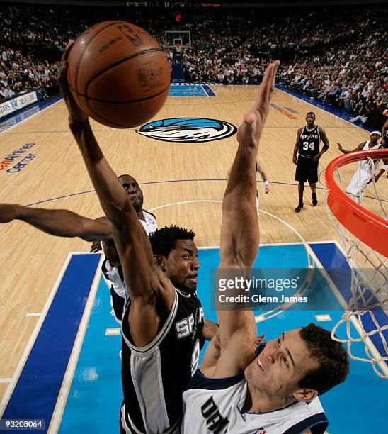 Roger Mason of the San Antonio Spurs goes up for the dunk against Kris Humphries of the Dallas Mavericks during a game at the American Airlines...