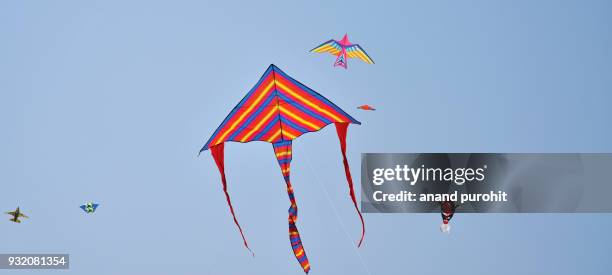 colourful kites in clear blue sky, ahmedabad, gujarat, india 2018 - pongal stock pictures, royalty-free photos & images