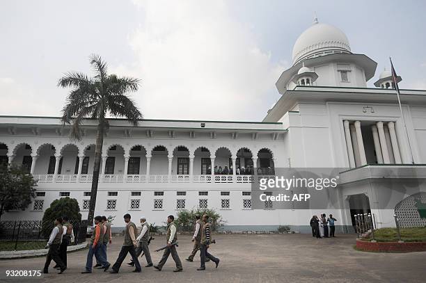 Bangladeshi security personnel stand guard at the Supreme Court in Dhaka on November 19, 2009. The Supreme Court rejected appeals of five men...