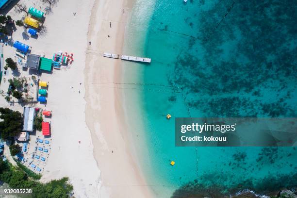 there are various color roofs on the beach. - kyushu stock pictures, royalty-free photos & images