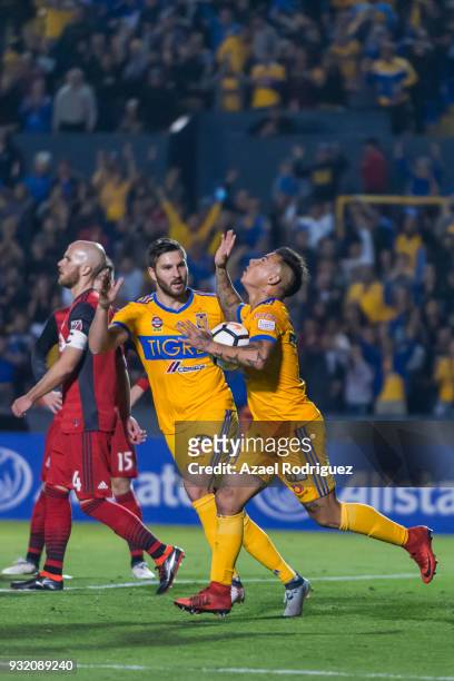 Eduardo Vargas of Tigres celebrates with teammate Andre-Pierre Gignac after scoring his team's first goal during the quarterfinals second leg match...