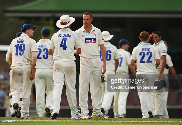 Doug Bollinger of the Blues is congratulated by team mate Stuart Clark after catching out Tim MacDonald of the Tigers during day three of the...