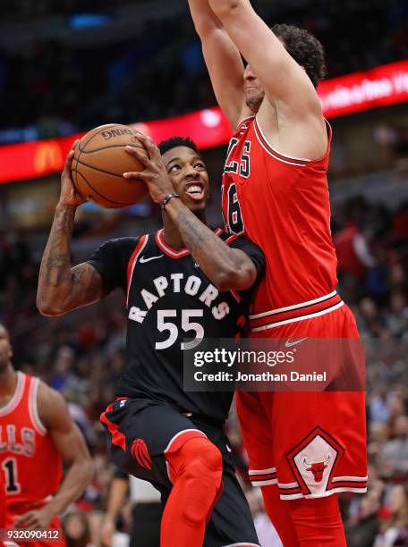 Delon Wright of the Toronto Raptors goes up against Paul Zipser of the Chicago Bulls at the United Center on February 14, 2018 in Chicago, Illinois....