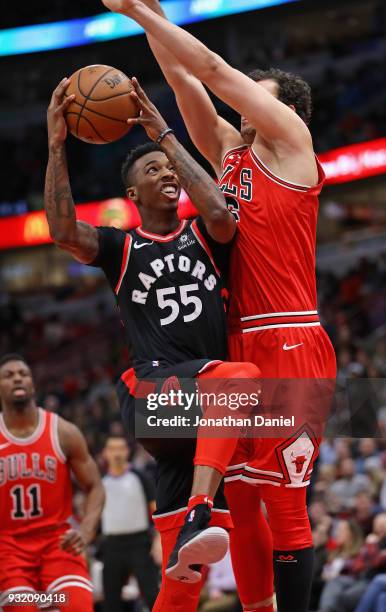 Delon Wright of the Toronto Raptors goes up against Paul Zipser of the Chicago Bulls at the United Center on February 14, 2018 in Chicago, Illinois....