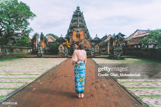 woman walking in balinese temple - bali temples stock pictures, royalty-free photos & images