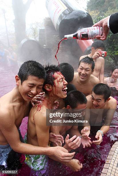 Sommelier pours a bottle of Beaujolais Nouveau to an open air wine spa at the Hakone Kowakien Yunessun on November 19, 2009 in Hakone, Kanagawa,...