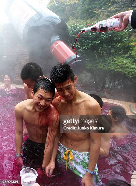 Sommelier pours a bottle of Beaujolais Nouveau to an open air wine spa at the Hakone Kowakien Yunessun on November 19, 2009 in Hakone, Kanagawa,...