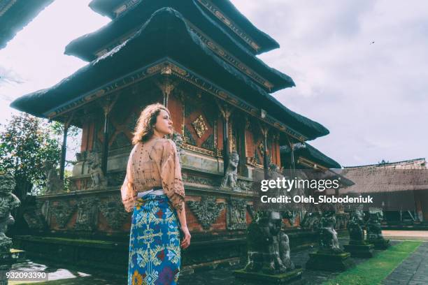 woman walking in balinese temple - balinese culture stock pictures, royalty-free photos & images