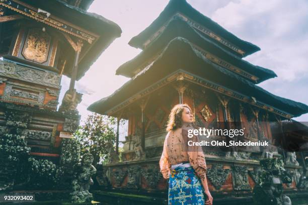 woman walking in balinese temple - bali stock pictures, royalty-free photos & images