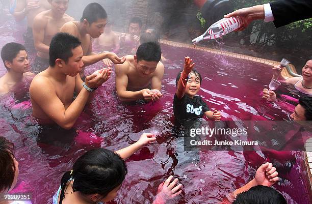 Sommelier pours a bottle of Beaujolais Nouveau to an open air wine spa at the Hakone Kowakien Yunessun on November 19, 2009 in Hakone, Kanagawa,...