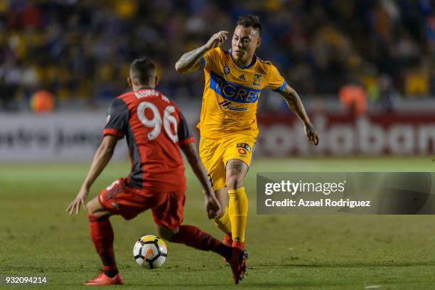 Eduardo Vargas of Tigres fights for the ball with Auro Junior of Toronto during the quarterfinals second leg match between Tigres UANL and Toronto FC...