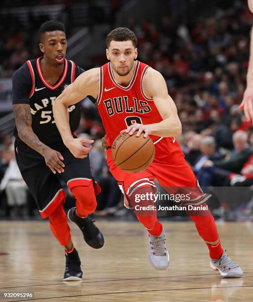Zach LaVine of the Chicago Bulls moves past Delon Wright of the Toronto Raptors at the United Center on February 14, 2018 in Chicago, Illinois. The...