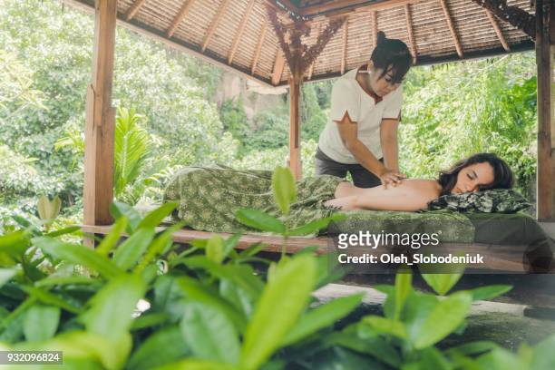 woman receiving  massage in bali - bali spa stock pictures, royalty-free photos & images