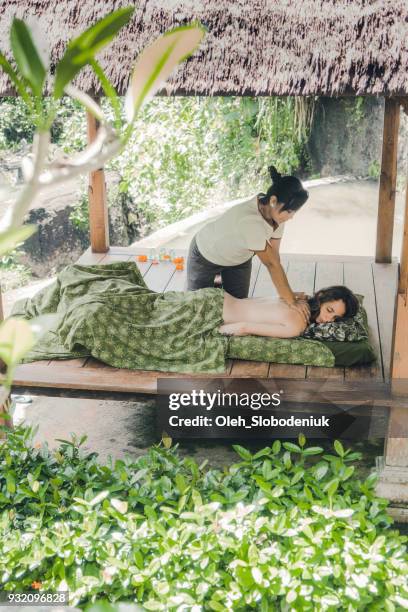 woman receiving  massage in bali - bali spa stock pictures, royalty-free photos & images