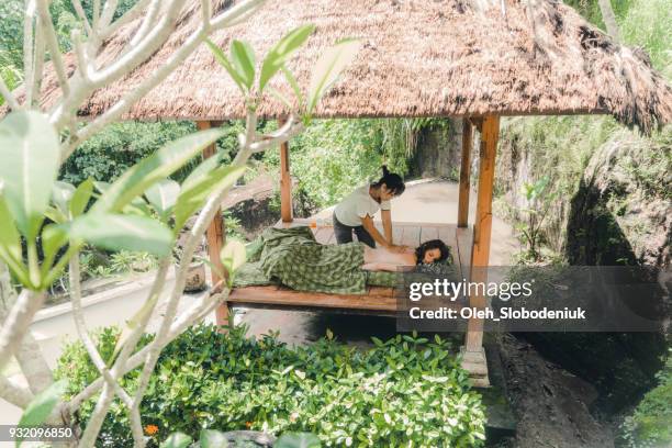 woman receiving  massage in bali - bali spa stock pictures, royalty-free photos & images