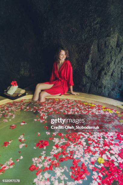 woman taking hot tub with flower petals - robe rose stock pictures, royalty-free photos & images