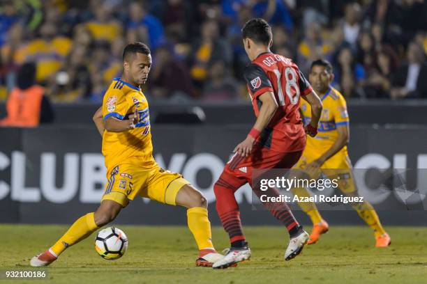 Rafael De Souza of Tigres fights for the ball with Marky Delgado of Toronto during the quarterfinals second leg match between Tigres UANL and Toronto...