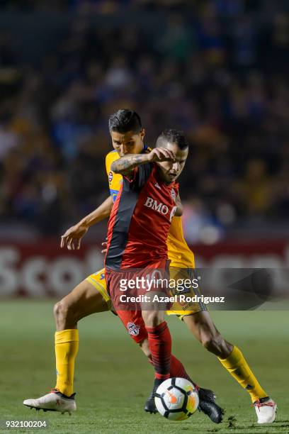 Hugo Ayala of Tigres fights for the ball with Sebastian Giovinco of Toronto during the quarterfinals second leg match between Tigres UANL and Toronto...