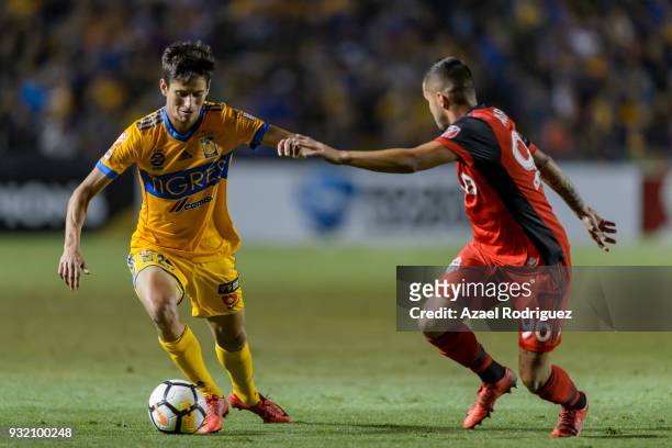 Jurgen Damm of Tigres fights for the ball with Auro Junior of Toronto during the quarterfinals second leg match between Tigres UANL and Toronto FC as...