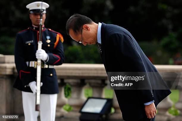 Singapore Foreign Minister George Yeo bows in front of the statue of Philippine's national hero Jose Rizal during a wreath laying ceremony in Manila...