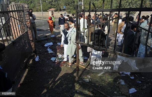 Pakistani security officials gather at the site of a suicide bomb blast in Peshawar on November 19, 2009. A suicide bomber struck outside a Pakistan...