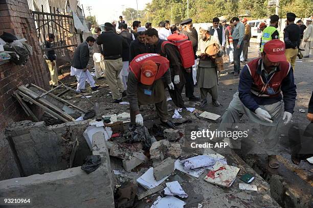 Pakistani security officials gather at the site of a suicide bomb blast in Peshawar on November 19, 2009. A suicide bomber struck outside a Pakistan...