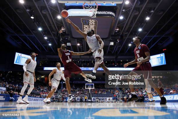 Raasean Davis of the North Carolina Central Eagles blocks a shot by Donte Clark of the Texas Southern Tigers in the first half during the First Four...