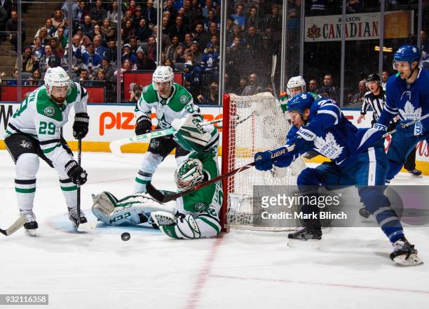 Connor Brown of the Toronto Maple Leafs tries for a wrap around on Kari Lehtonen of the Dallas Stars as Greg Pateryn and Antoine Roussel defend...