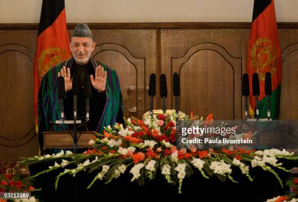 President Hamid Karzai reacts to applause from the crowd after taking the oath of office during the Inauguration ceremony at the presidential palace...