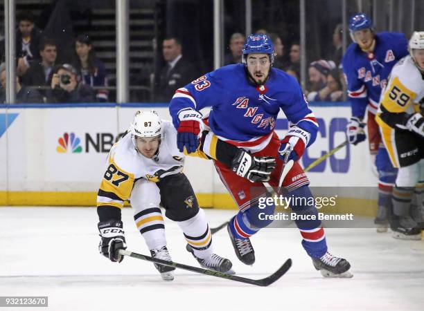 Sidney Crosby of the Pittsburgh Penguins holds back Mika Zibanejad of the New York Rangers during the second period at Madison Square Garden on March...