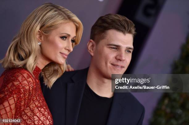 Personality Paris Hilton and actor Chris Zylka attend the 2018 iHeartRadio Music Awards at the Forum on March 11, 2018 in Inglewood, California.