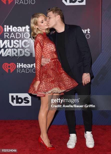 Personality Paris Hilton and actor Chris Zylka attend the 2018 iHeartRadio Music Awards at the Forum on March 11, 2018 in Inglewood, California.