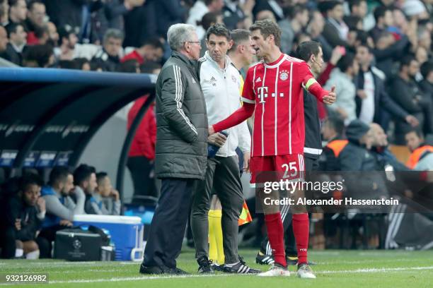 Jupp Heynckes, head coach of Bayern Muenchen talks to his player Thomas Mueller during the UEFA Champions League Round of 16 Second Leg match...